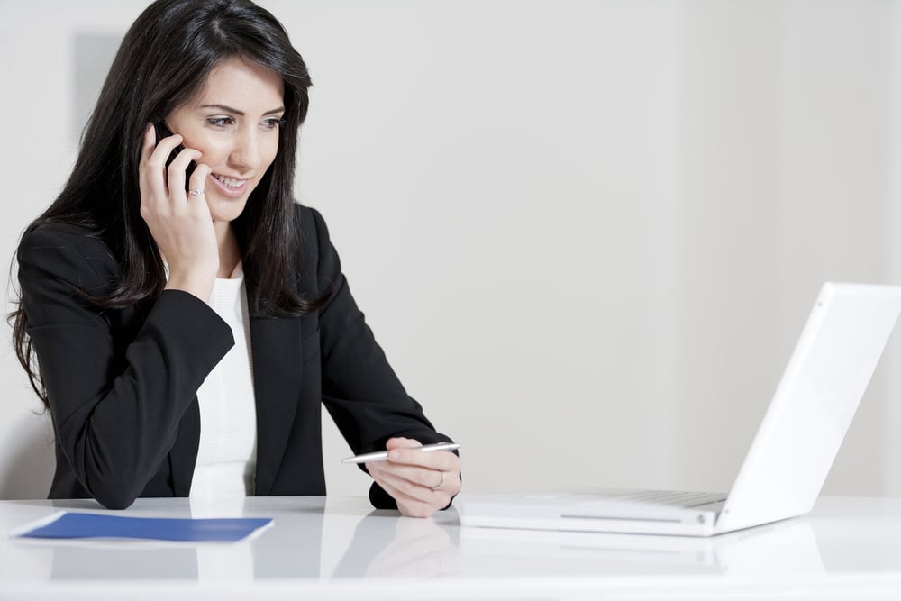 Young woman working at her desk in the office